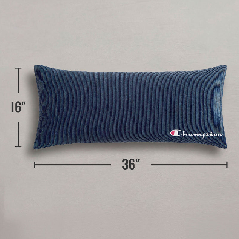 The Champion Corduroy Body Pillow from Champion, featuring a navy blue corduroy cover and the iconic logo embroidered in white on one end, measures 16 by 36 inches and adds signature comfort to any lounge area. It is displayed on a plain gray surface.