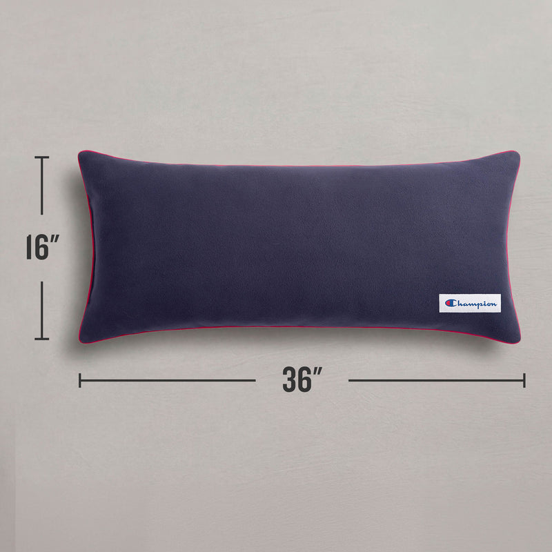 A Champion Faux Wool Body Pillow in a rectangular navy blue design with red piping, measuring 16 by 36 inches, rests on a gray surface. This cozy accent from Champion features a small branded logo tag on the corner, making it an ideal addition to any space.