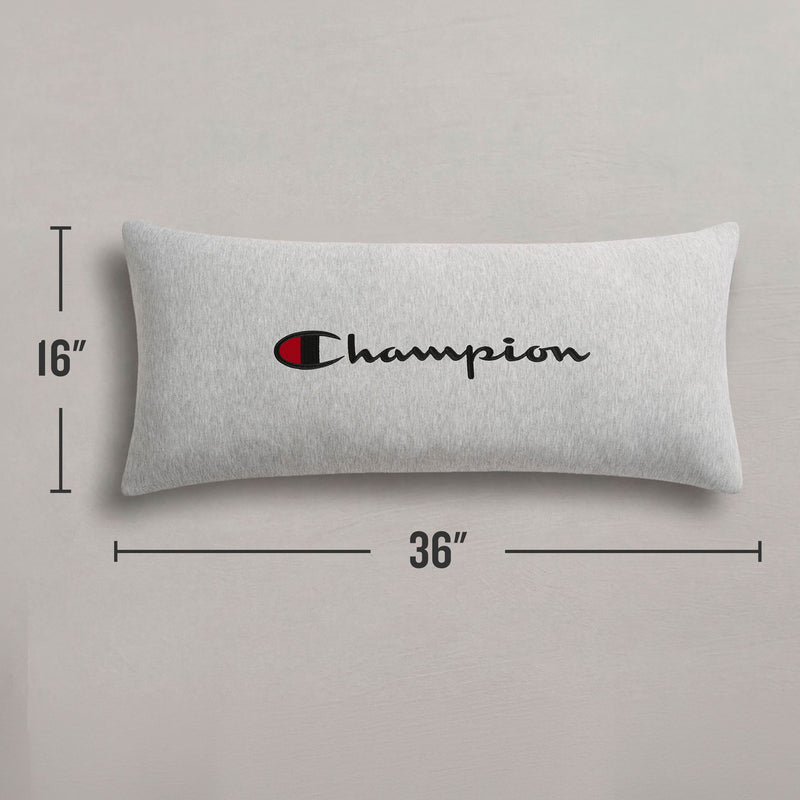 A Champion Jersey Body Pillow in gray, featuring the "Champion" logo in bold black and red font. Made from soft jersey-knit polyester, this rectangular pillow by Champion offers full-length cushioning and measures 16 inches tall by 36 inches wide, displayed against a light background.