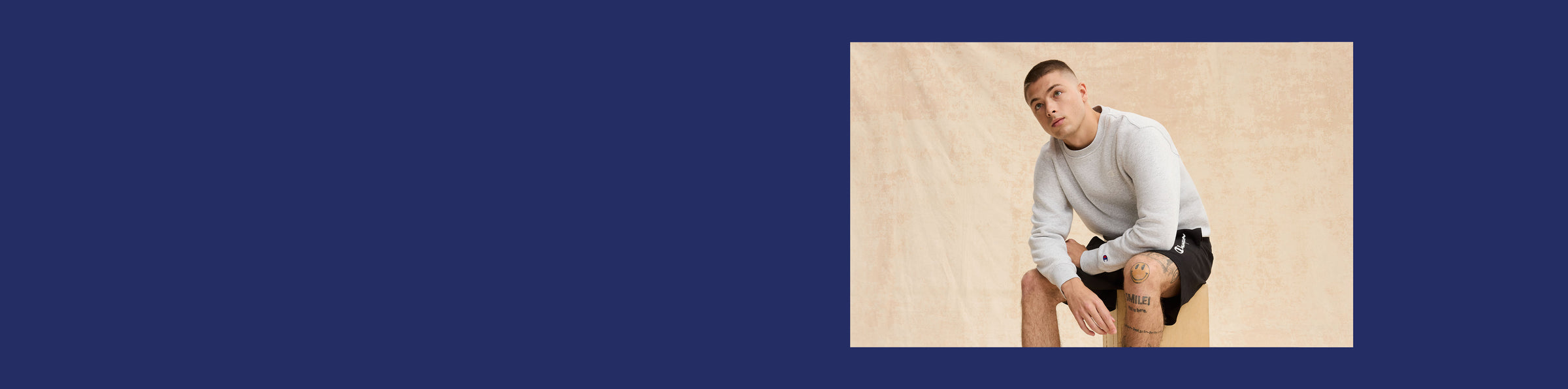 Man sitting on a sandy surface with a blue border
