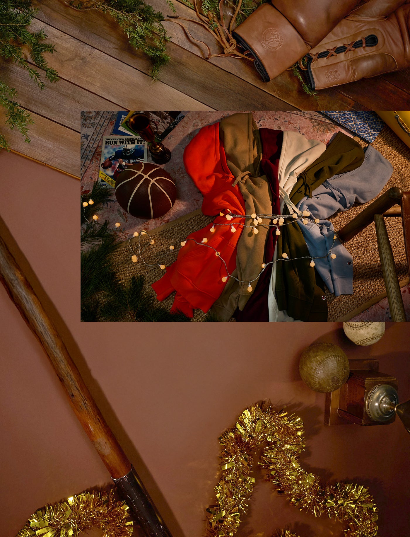 Decorative setup with a red bow, greenery, and festive lights on a wooden surface.