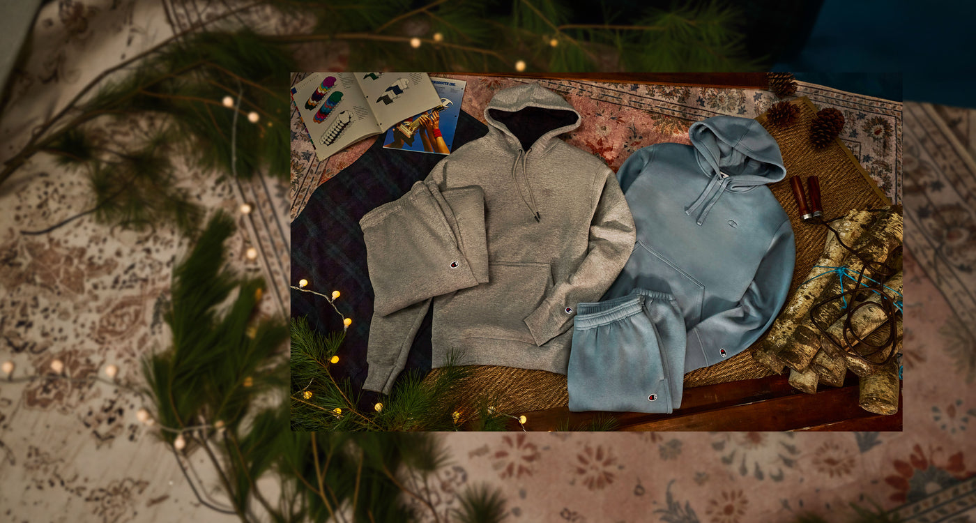 Collection of hoodies on a textured surface with decorative elements