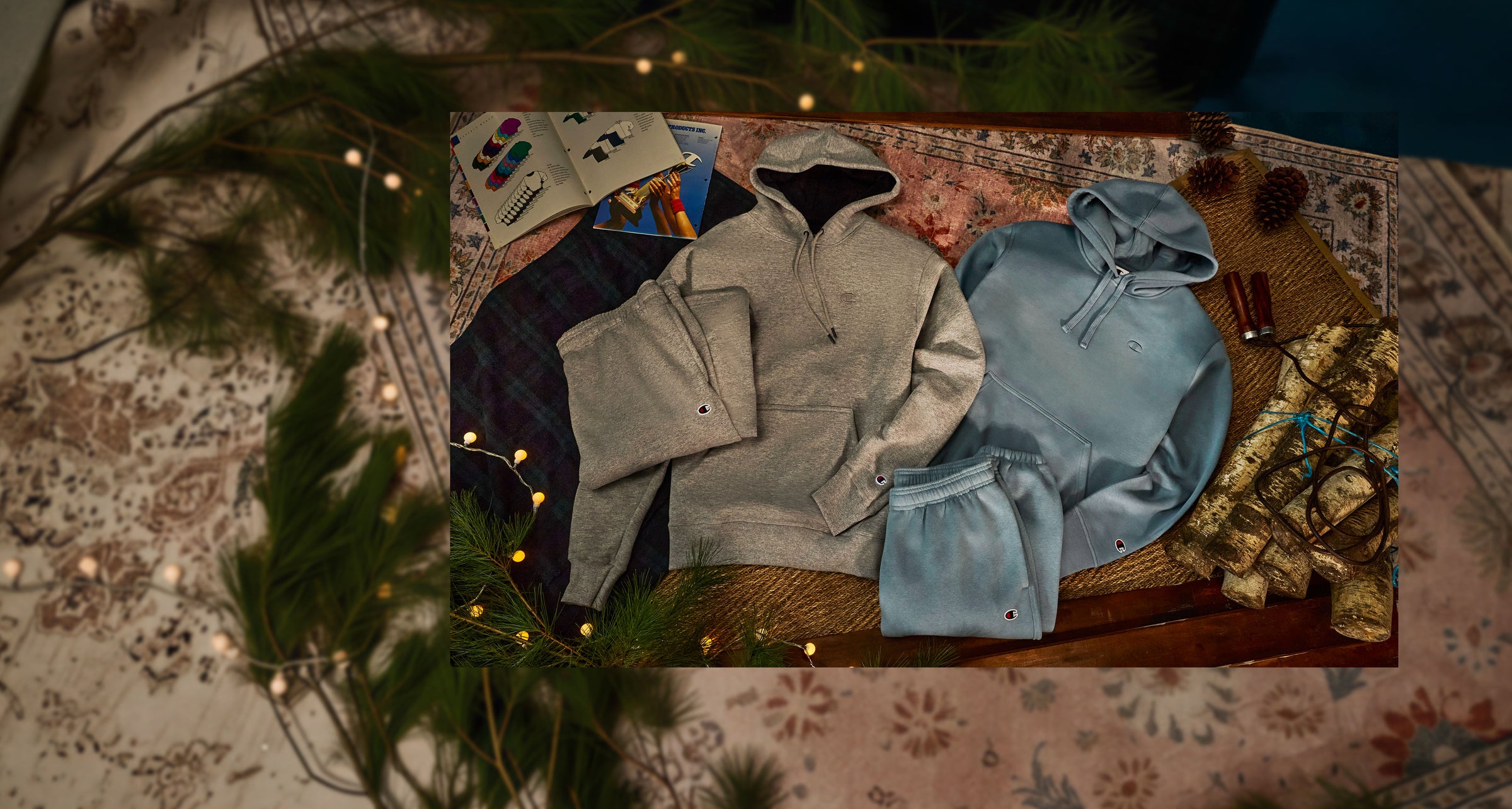 Collection of hoodies on a textured surface with decorative elements