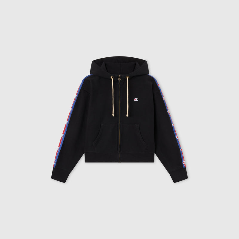 Women’s Icon Hooded Full Zip Sweatshirt by Champion features front pockets, hood drawstrings, and blue-and-red logo stripes on both sleeves. Made from heavyweight fleece and shown on a plain gray background.
