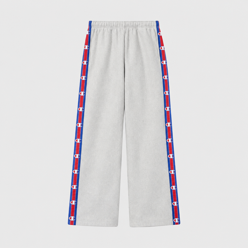Light gray Champion Women’s Knitted Wide Leg Pants featuring a vertical stripe down each leg with a repeating logo pattern in red, white, and blue.