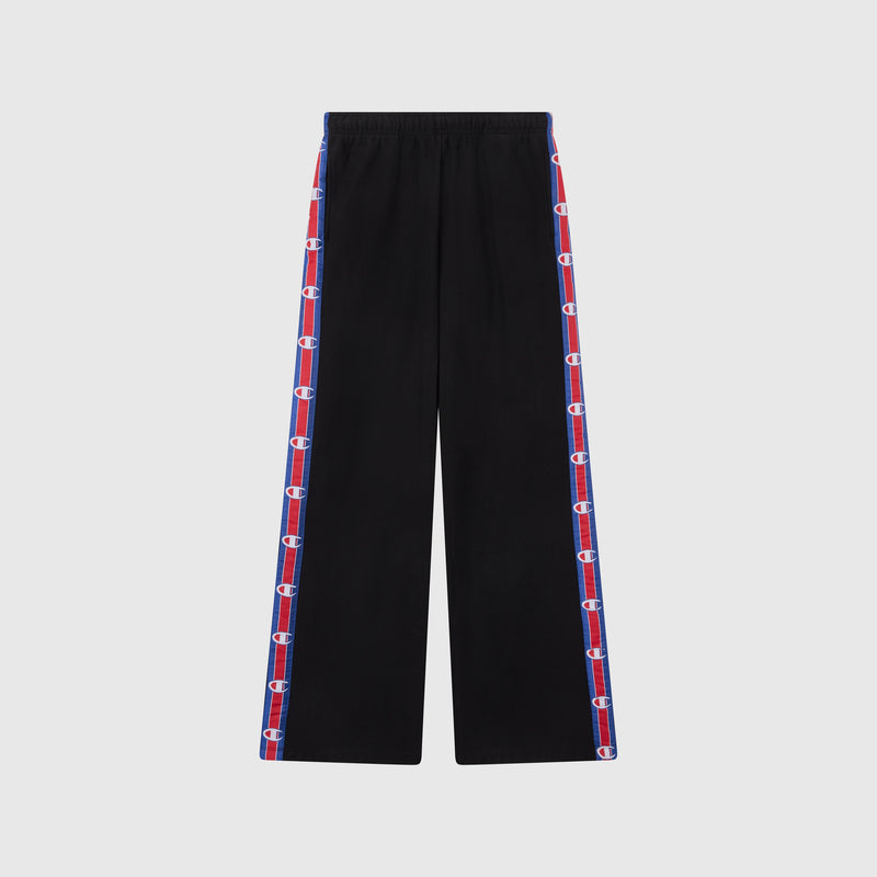 Women’s Knitted Wide Leg Pants by Champion in black, featuring blue and red striped side panels with repeated Champion logos. These pants have a relaxed fit, an elastic waistband, and are photographed against a plain light gray background.