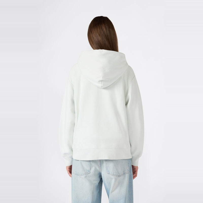 A person with long brown hair is shown from behind wearing a light-colored Champion Women’s Knitted Hooded Full Zip Sweatshirt and light blue jeans against a plain white background.