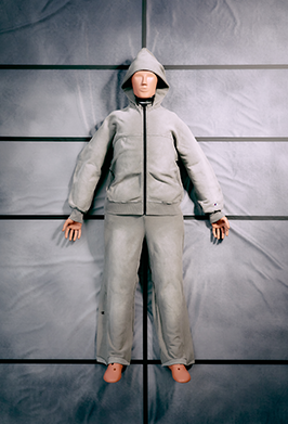 A light gray hooded puffer jacket and matching pants set displayed on a mannequin against a gray paneled backdrop.