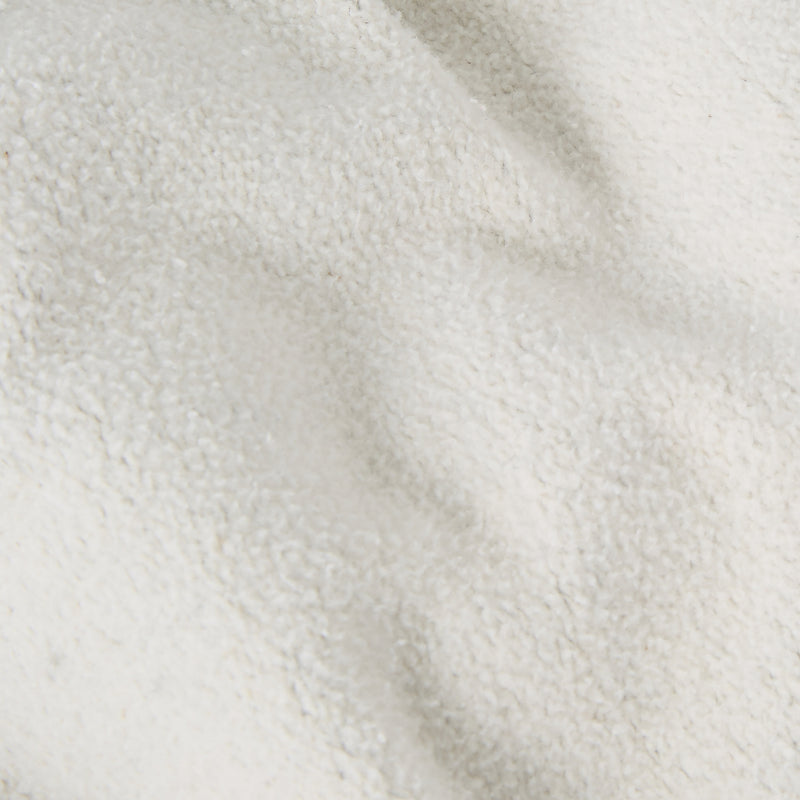 Close-up of a textured, off-white fleece fabric from the Champion Men’s Knitted Hooded Sweatshirt (College Graphic), featuring soft folds and a subtly bumpy surface that evokes the cozy sophistication of college-inspired style.