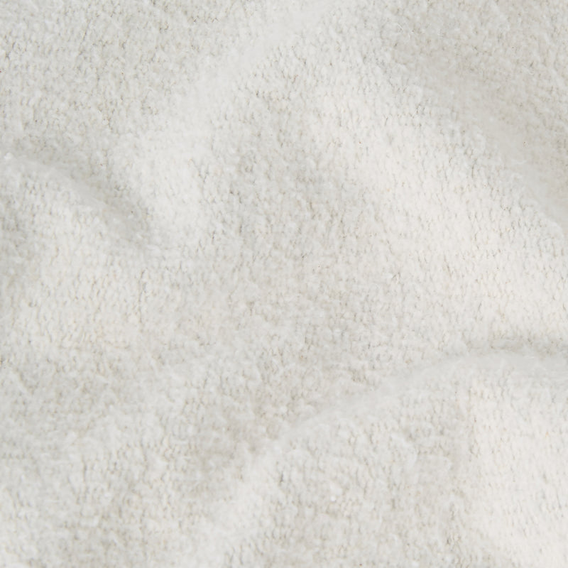 Close-up of a soft, white, textured fabric with gentle folds and a slightly fluffy appearance—evoking the cozy comfort characteristic of the Champion Men’s Knitted Polo Neck Sweatshirt.