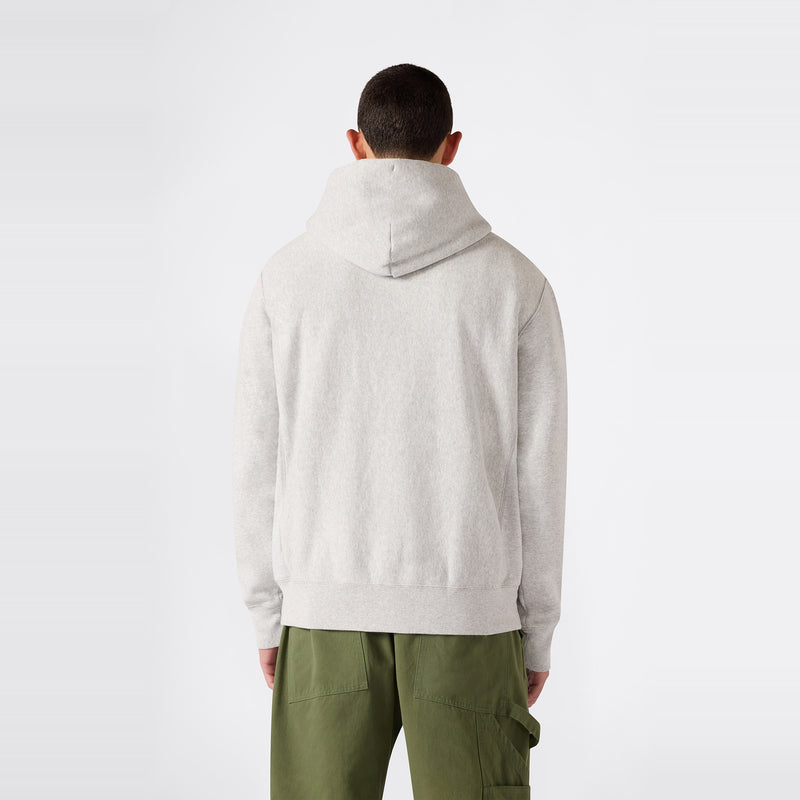 A person facing away, dressed in the Champion Men’s Knitted Hooded Sweatshirt in light gray and olive green cargo pants, stands against a plain white background.