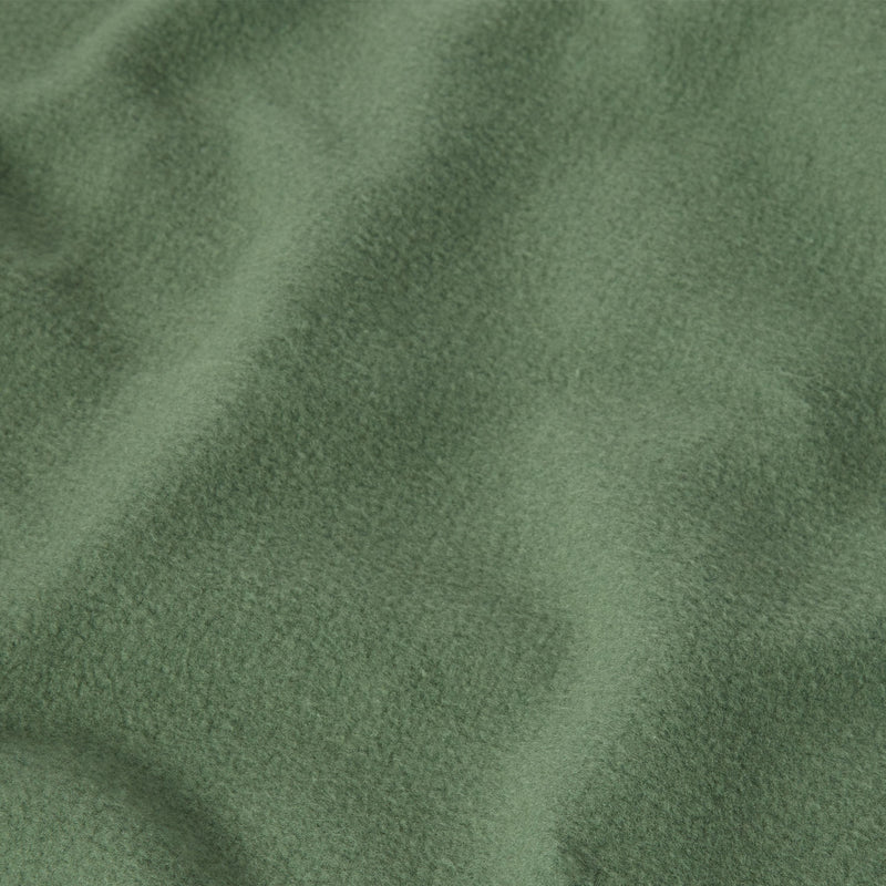 A close-up of heavyweight fleece fabric from the Champion Men’s Relaxed Fit Crewneck Sweatshirt, displaying a soft, textured surface with gentle folds and shadows.
