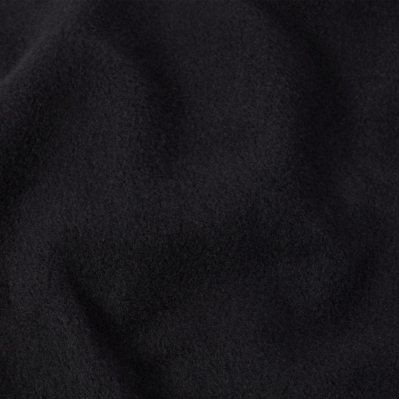 Close-up of soft, deep black fabric with a subtly fuzzy texture and gentle folds, evoking the feel of a classic Champion Men’s Knitted Crewneck Sweatshirt.