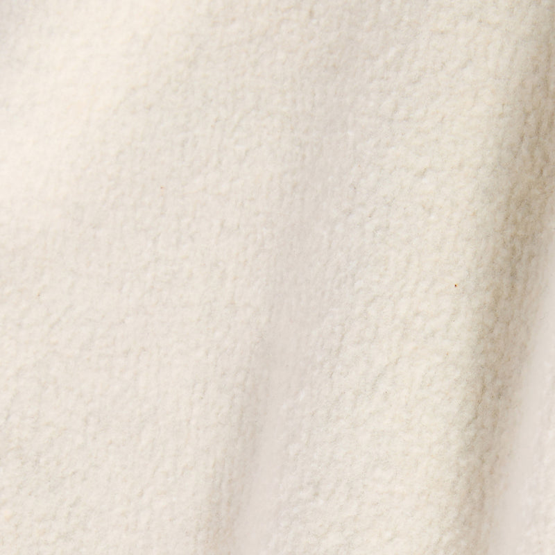 A close-up of a soft, off-white textured fabric with subtle shadows and a slightly fuzzy, woolly appearance—characteristic of the heavyweight fleece used in Champion Men’s Knitted Wide Leg Pants.