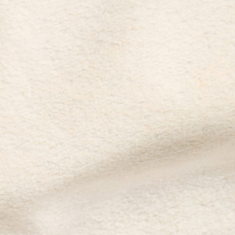 A close-up view of a soft, cream-colored, textured fabric surface with subtle folds and gentle shadows, reminiscent of the Champion Men’s Knitted Half Zip Sweatshirt.