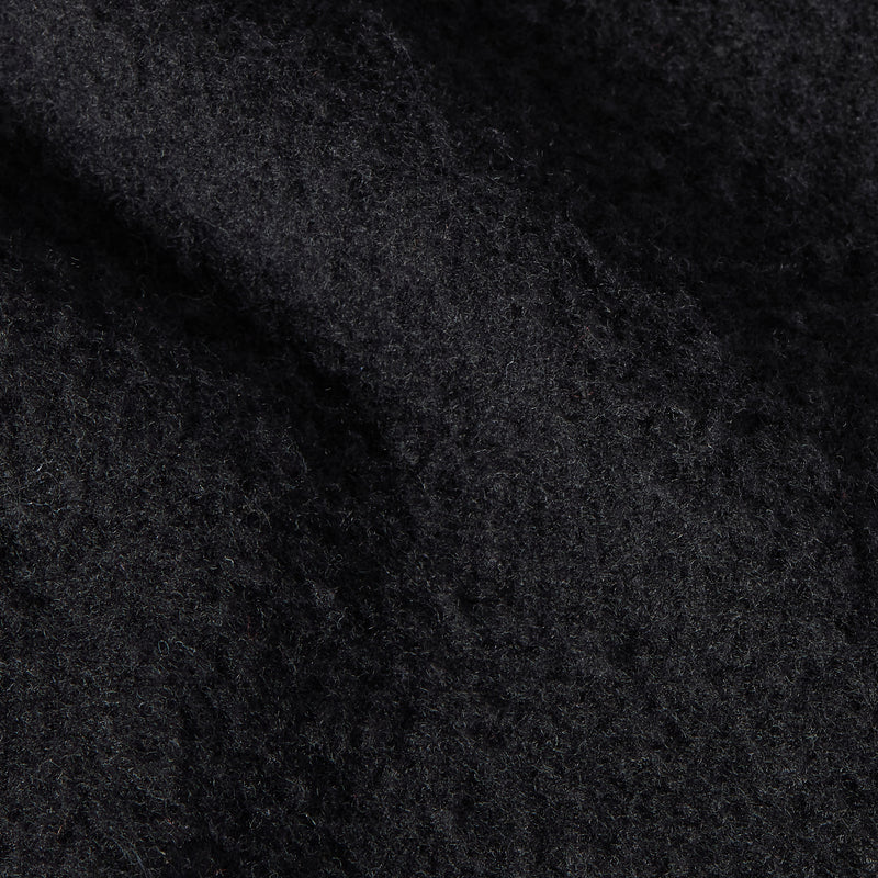 Close-up of the black, fuzzy textured fleece fabric of the Champion Men’s Knitted Crewneck Sweatshirt, highlighting its soft, slightly uneven surface with subtle highlights and shadows characteristic of this classic style.