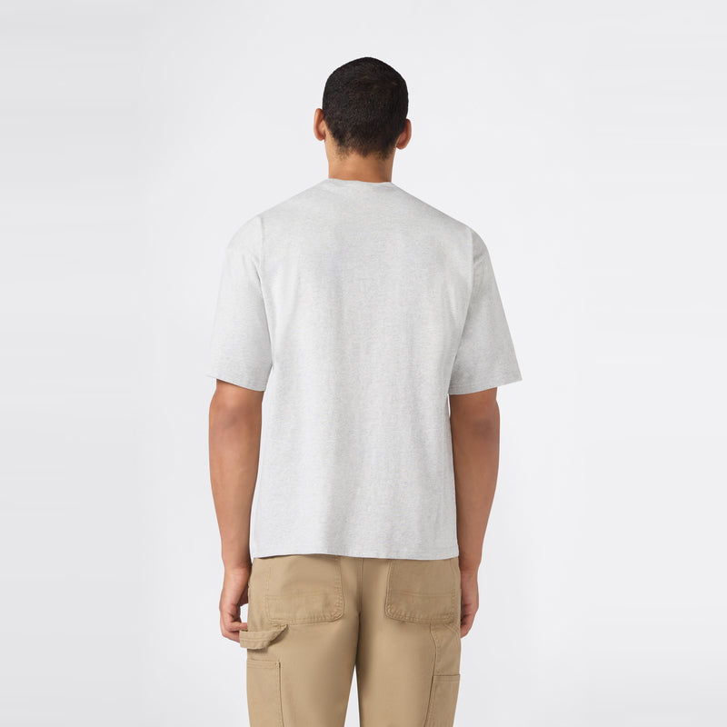 A person stands facing away from the camera, wearing a Champion Men’s Knitted T-Shape Tee in light gray and tan cargo pants, against a plain white background.