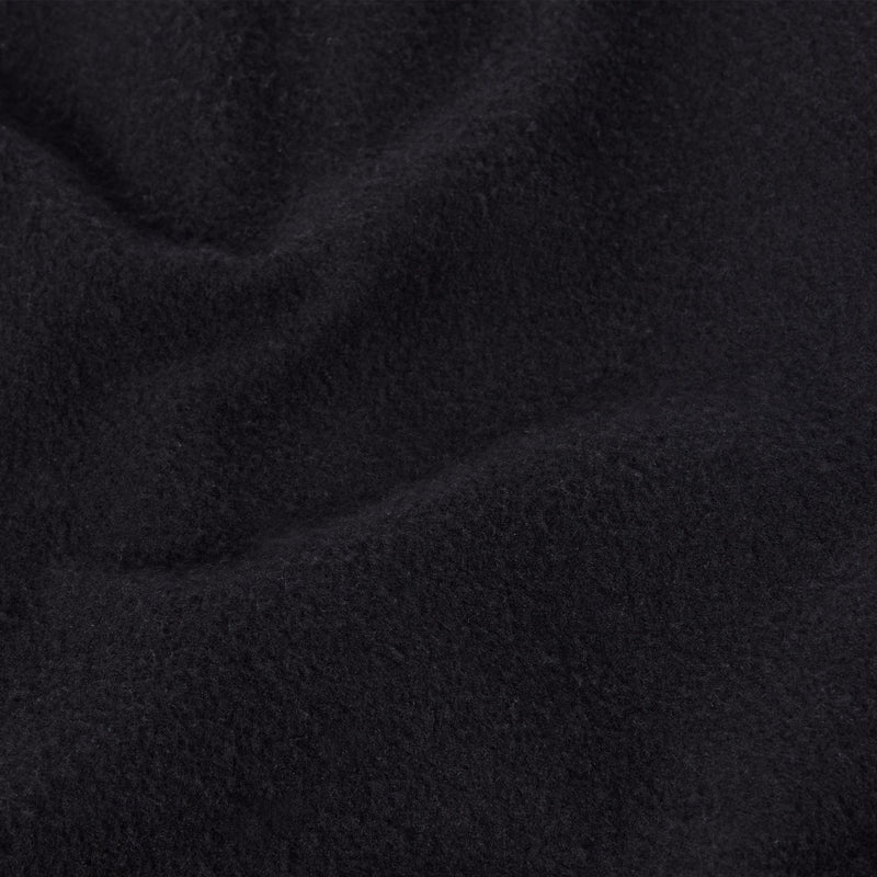 A close-up view of soft, black heavyweight fleece fabric with gentle folds and a slightly textured, fuzzy surface, reminiscent of the quality found in Champion Men’s Knitted Shorts—a staple in men’s sportswear.