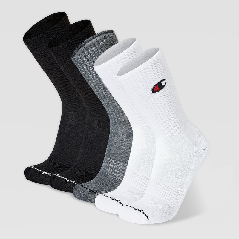 Five pairs of Champion 5Pk Mens Cushion Crew socks in black, dark gray, light gray, and white with cushioned support. The white pair features the Champion logo; all have “champion” text on the toes and are shown on a plain gray background.