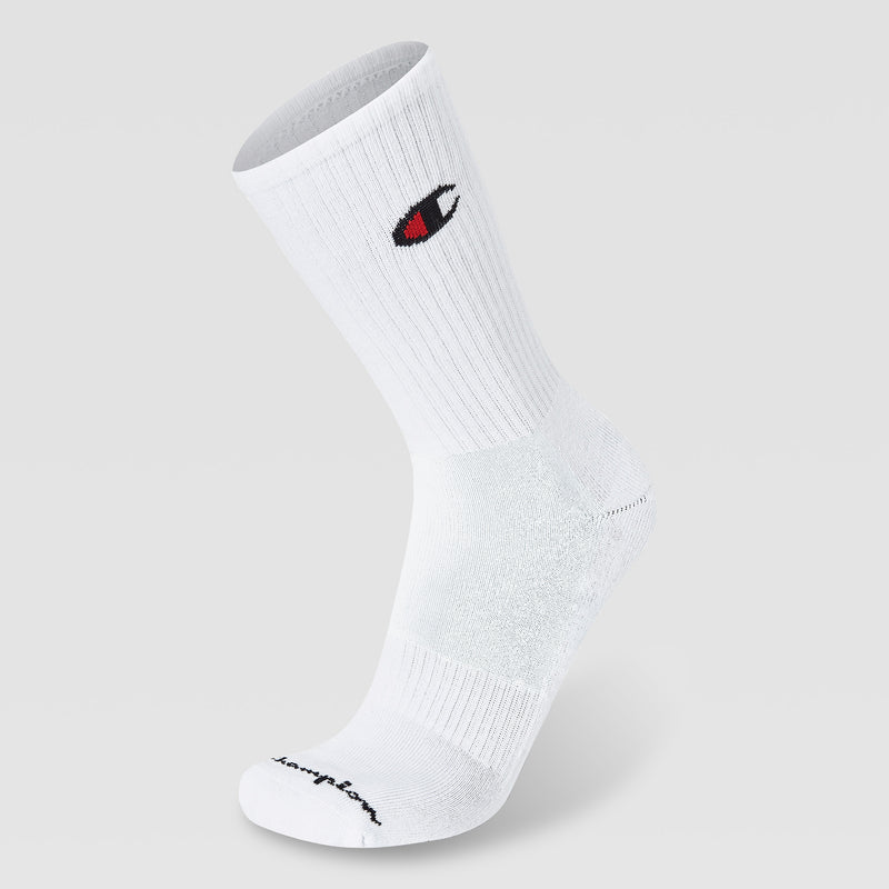 A single white crew sock from the Champion 5Pk Mens Cushion Crew, with ribbed material, cushioned support, and a red, black, and white Champion logo near the top. "Champion" in black script appears on the toe. Displayed on a gray background.