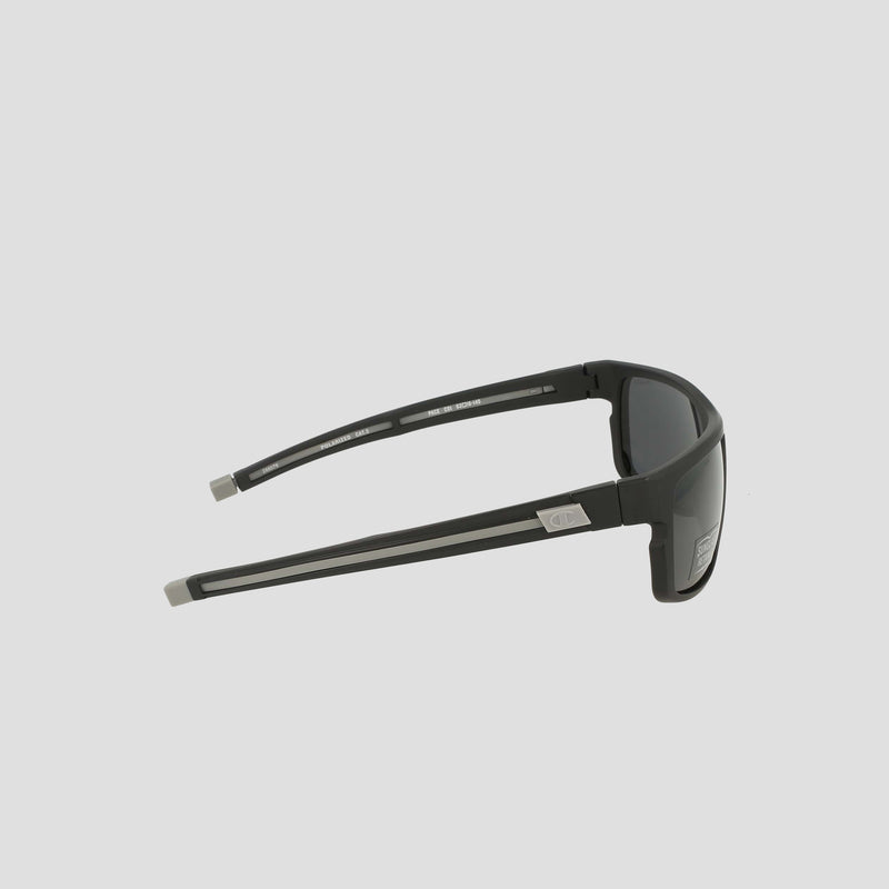 Men’s Polarized Wrap - Large sunglasses by Champion, featuring a black rectangular frame with dark polarized lenses and silver accents on the temple arms near the hinges, are shown from a side angle on a plain light grey background.