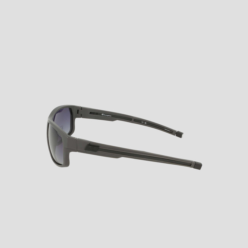 Side view of the Champion Men's Polarized Rectangle Retainer Wrap - Medium sunglasses in black, featuring thick arms and a modern, sporty design with dark tinted polarized lenses for enhanced visual clarity, displayed against a light gray background.