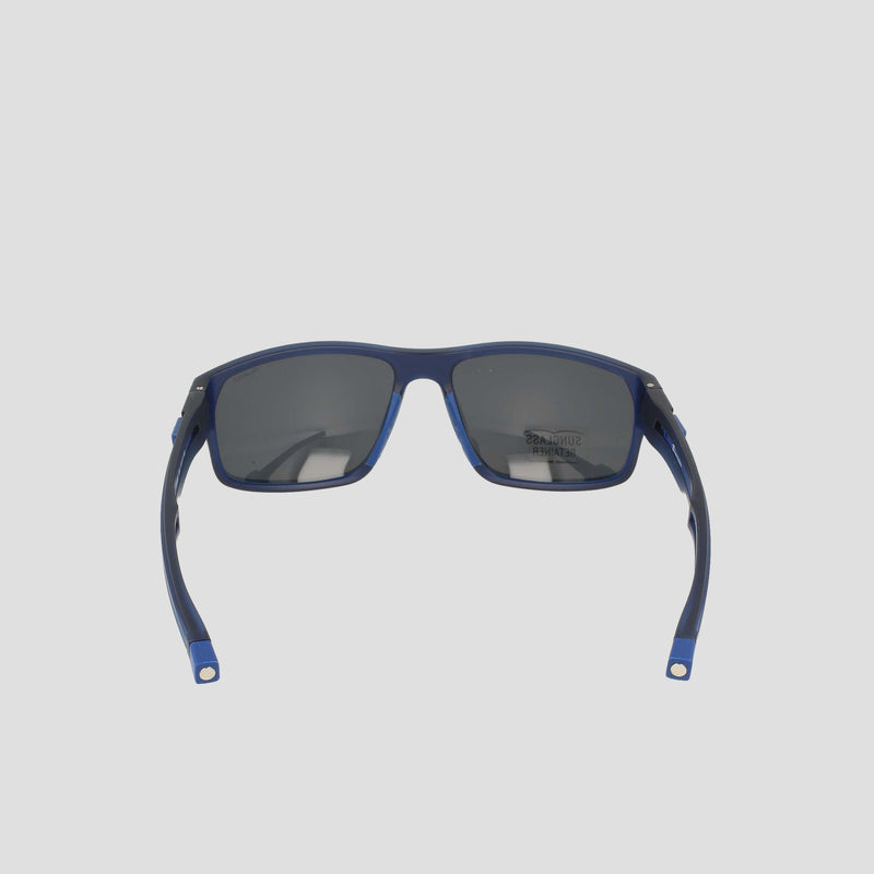 A pair of Champion Men's Polarized Rectangle Retainer Wrap sunglasses in blue, featuring dark polarized lenses, is displayed from the rear angle against a plain light gray background.