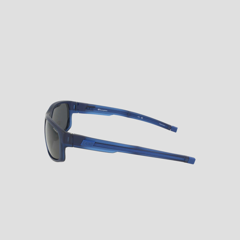 Champion Men's Polarized Rectangle Retainer Wrap - Medium sunglasses in solid blue, featuring dark polarized lenses and a slightly angular, sporty design inspired by men's retainer frames. Shown from the side against a plain light background.