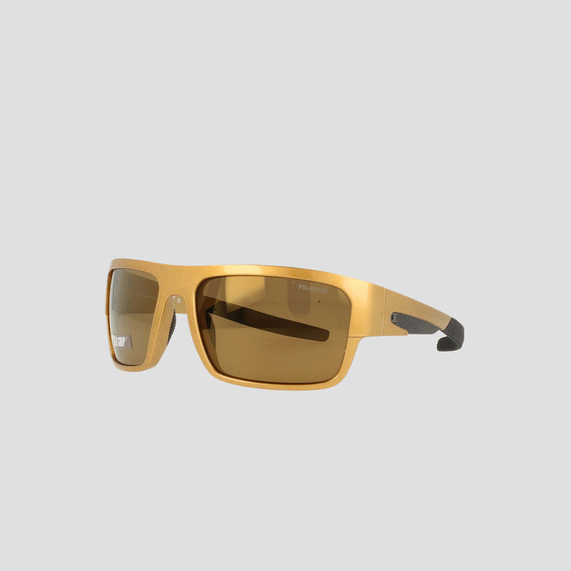 Champion Men's Polarized Grilamid Flex Grip Tip - Large sunglasses feature gold frames with brown tinted rectangular polarized lenses and black accents on the temple tips, set against a plain light gray background. Designed for lightweight comfort, this RX-able frame by Champion seamlessly combines style and functionality.