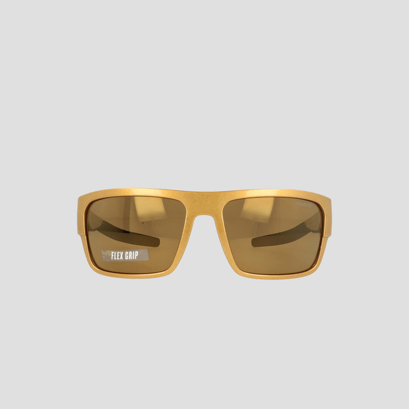 Champion Men's Polarized Grilamid Flex Grip Tip - Large sunglasses in yellow rectangular frames, featuring brown tinted polarized lenses. "FLEX GRIP" is printed in white on the lower corner of the left lens. Designed by Champion for lightweight comfort, these sunglasses also have an RX-able frame for added versatility, and are shown against a plain light grey background.