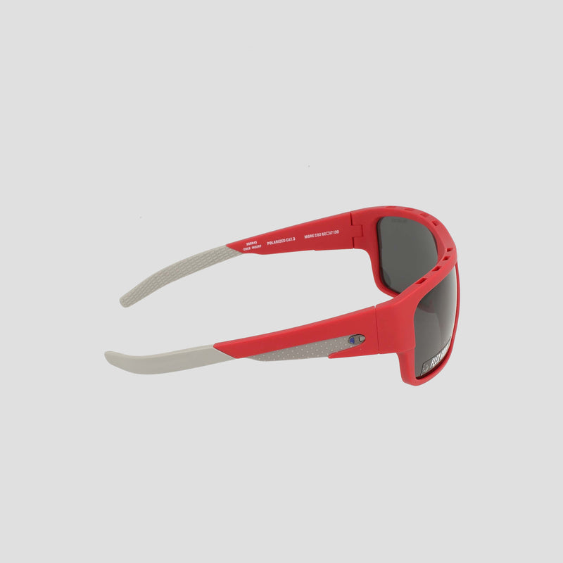 Champion Men's Polarized Grilamid Flex Grip Tip - Large sports sunglasses in red and gray, featuring black polarized lenses, are displayed from the side to showcase their modern, angular design with curved arms and textured gray Flex Grip tips near the ear ends. The lightweight RX-able frame offers all-day comfort.
