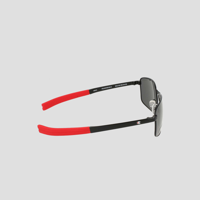 Side view of Champion Men's Polarized Stainless ST-Shirtl Flex Grip Tip sunglasses in black with striking red arms, adorned with a small white Champion logo on the side. The dark, polarized lenses are perfect for active lifestyles, displayed against a plain light grey background.