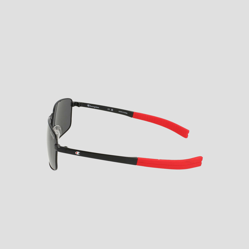 Champion Men's Polarized Stainless ST-Shirtl Flex Grip Tip sunglasses in black with red flex grip temple tips, displayed from the side against a plain, light gray background. Featuring polarized dark lenses and a men's retainer frame, these sleek, modern sunglasses are designed for active lifestyles.