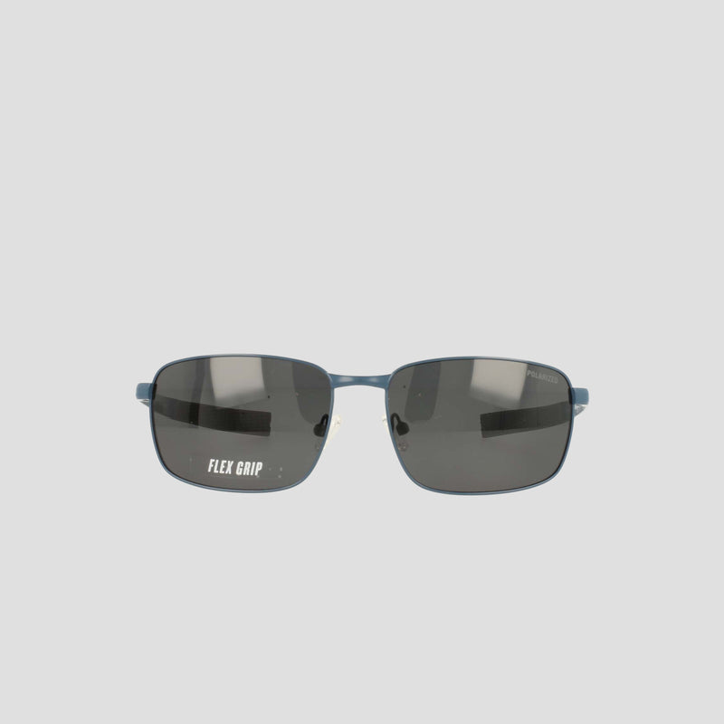 Front view of Champion Men's Polarized Stainless ST-Shirtl Flex Grip Tip sunglasses featuring dark polarized lenses, a blue frame, and “FLEX GRIP” text visible on the left lens—ideal for active lifestyles and designed with a men's retainer frame for secure comfort.