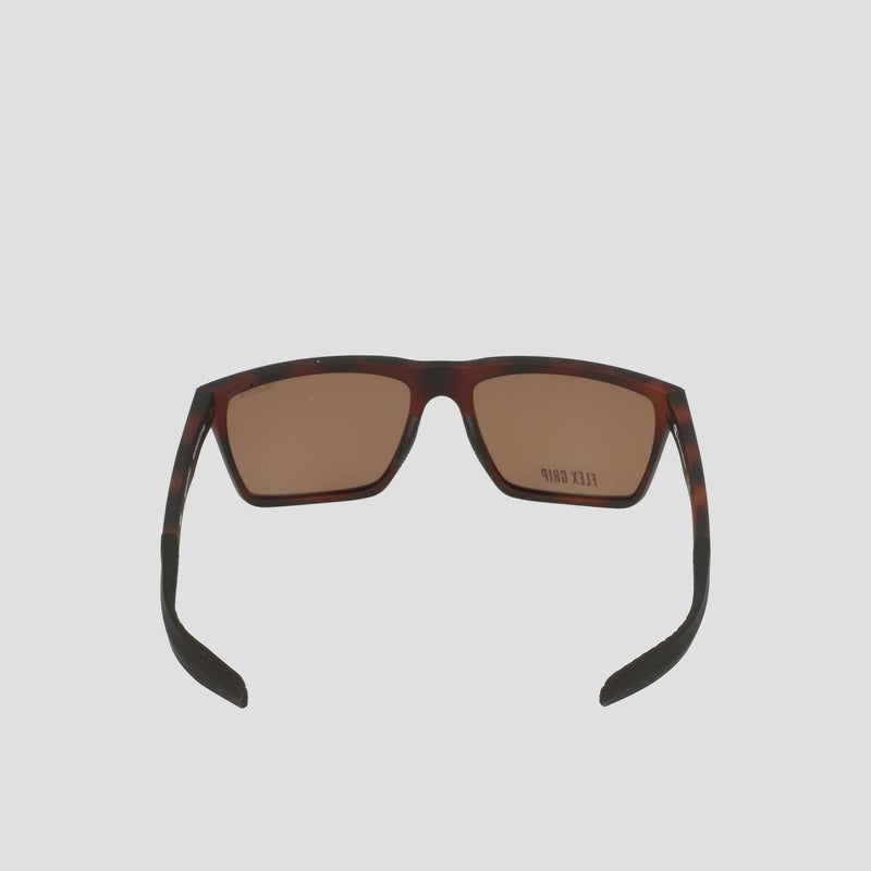 Champion Men's Polarized Grilamid Flex Grip Tip sunglasses in tortoiseshell, featuring brown polarized lenses and a lightweight, RX-able TR90 frame, viewed from the back with the arms extended outward against a plain, light background.