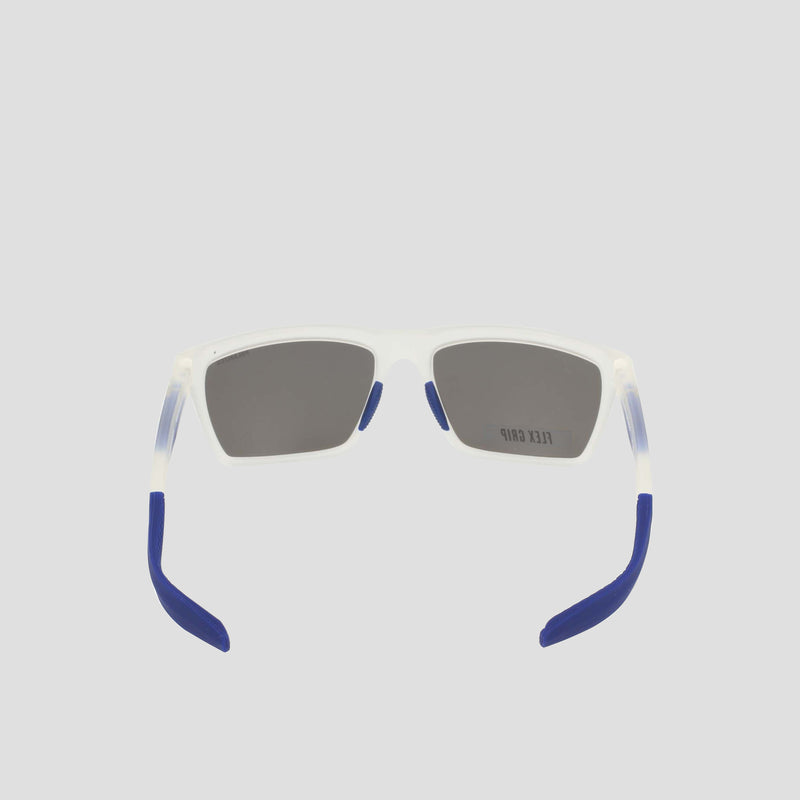 A pair of Champion Men's Polarized Grilamid Flex Grip Tip sunglasses in medium size, featuring rectangular translucent white RX-able TR90 frames with dark lenses and blue-tipped arms, is shown from the back against a plain light gray background.