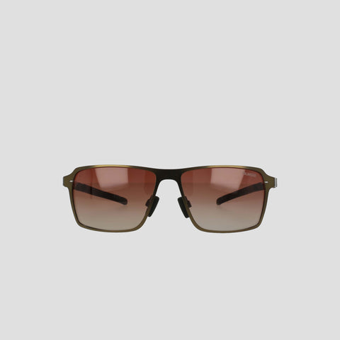 Champion Men's Polarized ST-Shirtl Comfort Fit sunglasses feature a thin stainless steel frame and brown gradient lenses with adjustable rubber tips, shown against a plain light gray background.