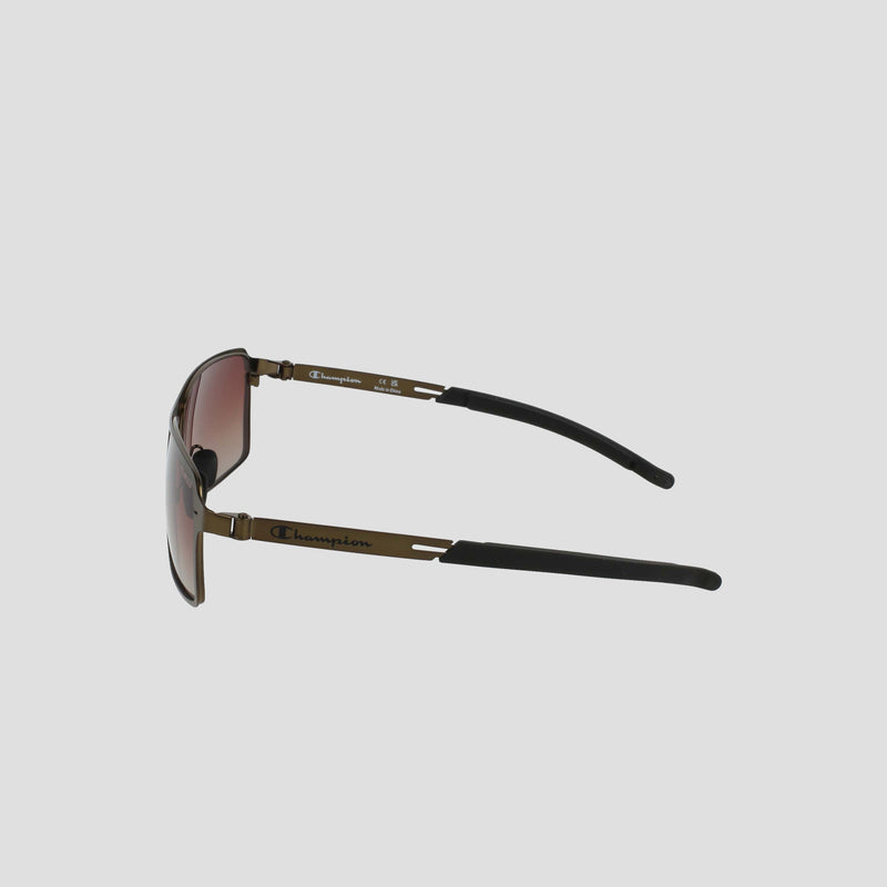 Side view of Champion Men's Polarized Stainless ST-Shirtl Comfort Fit sunglasses with brown-tinted polarized lenses, thin stainless steel frame, and black ear tips. Brand logo appears on the temple against a plain light grey background.