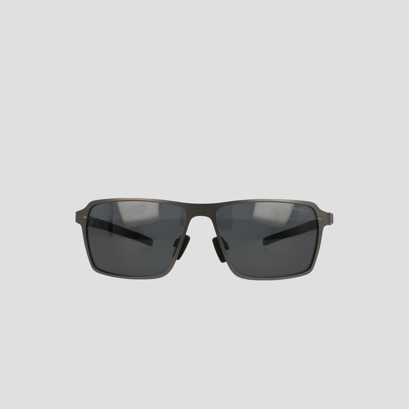 Champion Men’s Polarized Sunglasses feature dark lenses and a slim, dark stainless steel frame, displayed against a plain light grey background.