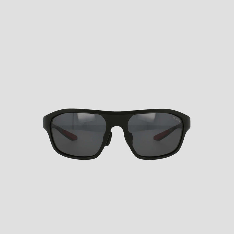 Champion Men's Polarized Comfort Fit - Large sports sunglasses, featuring a black, slightly curved TR90 frame with polarized lenses. The design includes adjustable rubber tips for enhanced comfort and a secure fit, displayed against a plain, light gray background.