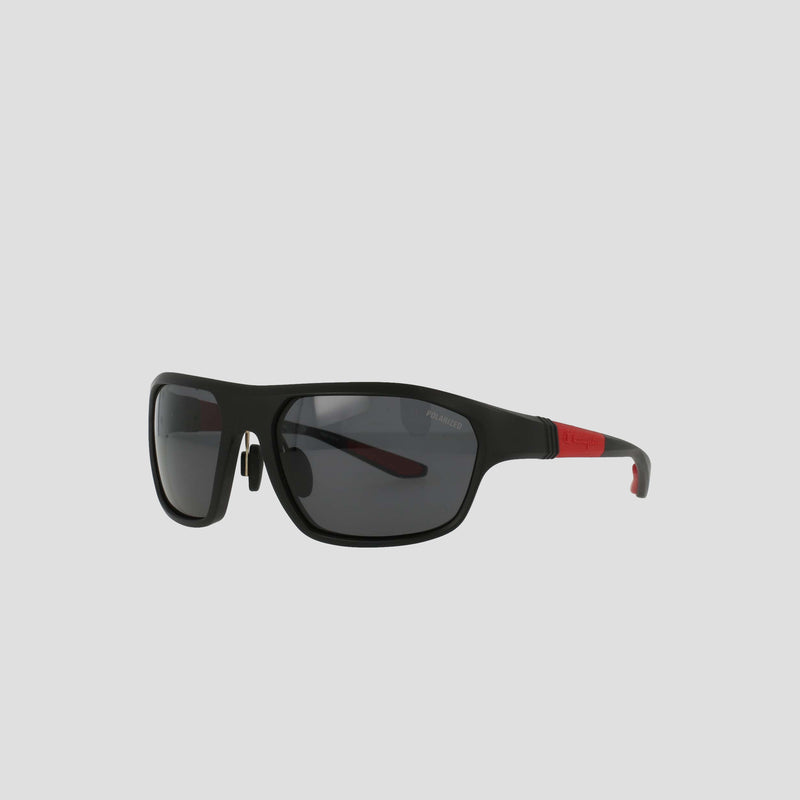 Champion Men's Polarized Comfort Fit - Large sunglasses feature a black rectangular design with a sleek TR90 frame, dark polarized lenses, and distinctive red accents on the temples. Adjustable rubber tips ensure added comfort, showcased against a light gray background.