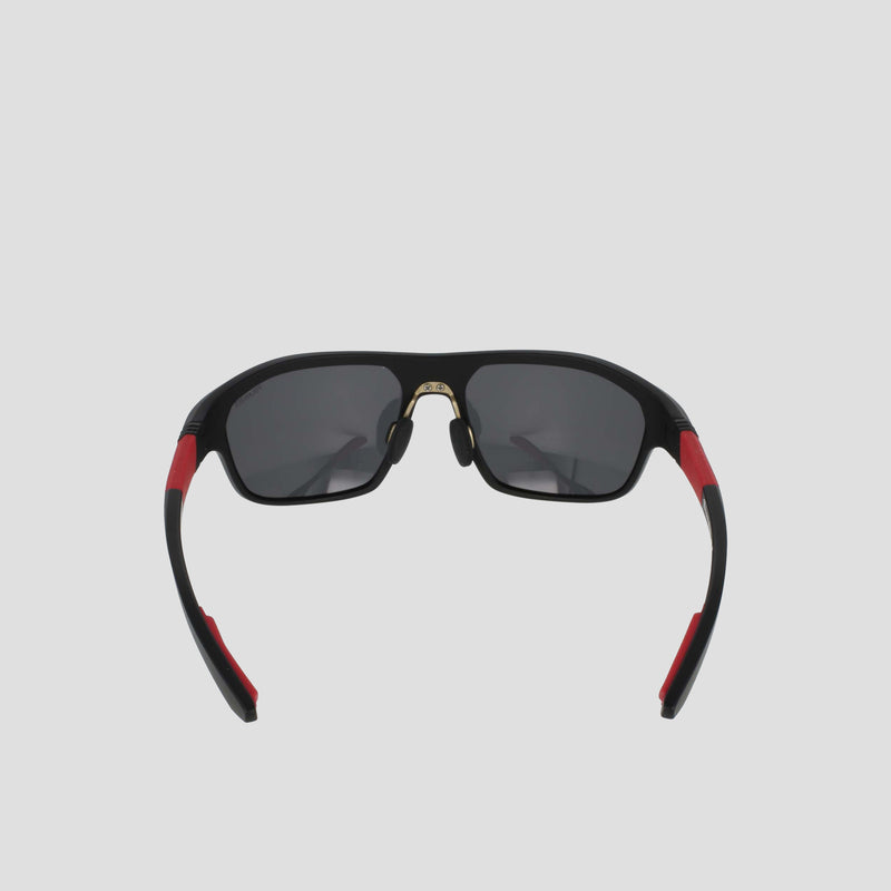 Champion Men's Polarized Comfort Fit - Large sunglasses with black, polarized dark lenses, accented by red details on the TR90 frame arms and a gold nose bridge, plus adjustable rubber tips, shown against a plain light gray background.