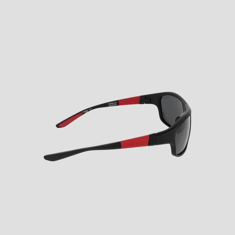 Champion Men's Polarized Comfort Fit - Large sunglasses, featuring a sporty TR90 frame in black with red accents on the temples, are displayed from a side angle against a light grey background. The polarized lenses ensure superior glare reduction, while the lightweight and durable design offers exceptional comfort.
