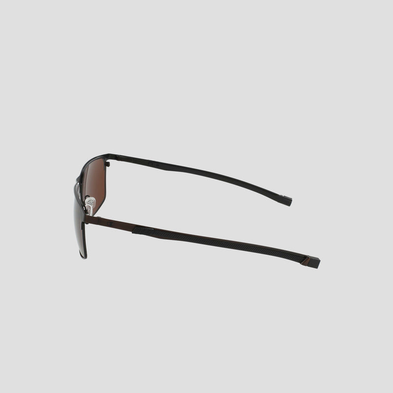A pair of Champion Men's Polarized Retainer Stainless ST-Shirtl Square sunglasses, featuring black frames with brown tinted polarized lenses, viewed from the side against a plain light gray background. The slim, slightly curved arms and retainer frame provide a modern touch to the sleek men’s design.