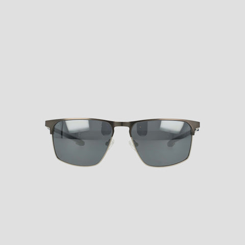 Champion Men's Polarized Retainer ST-Shirtl Square sunglasses feature a rectangular stainless steel frame with dark polarized lenses and adjustable nose pads, showcased against a plain light gray background.