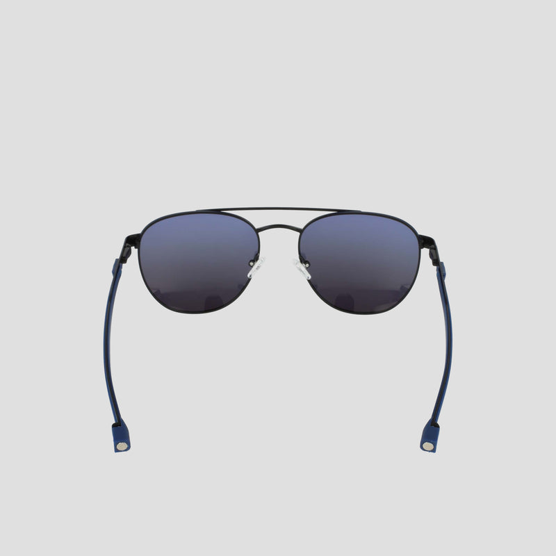 A pair of Champion Men's Polarized Retainer Stainless ST-Shirtl Aviator sunglasses with black rims, blue-tinted polarized lenses, and blue flexible temple tips, featuring an adjustable nose bridge, displayed against a plain light gray background.