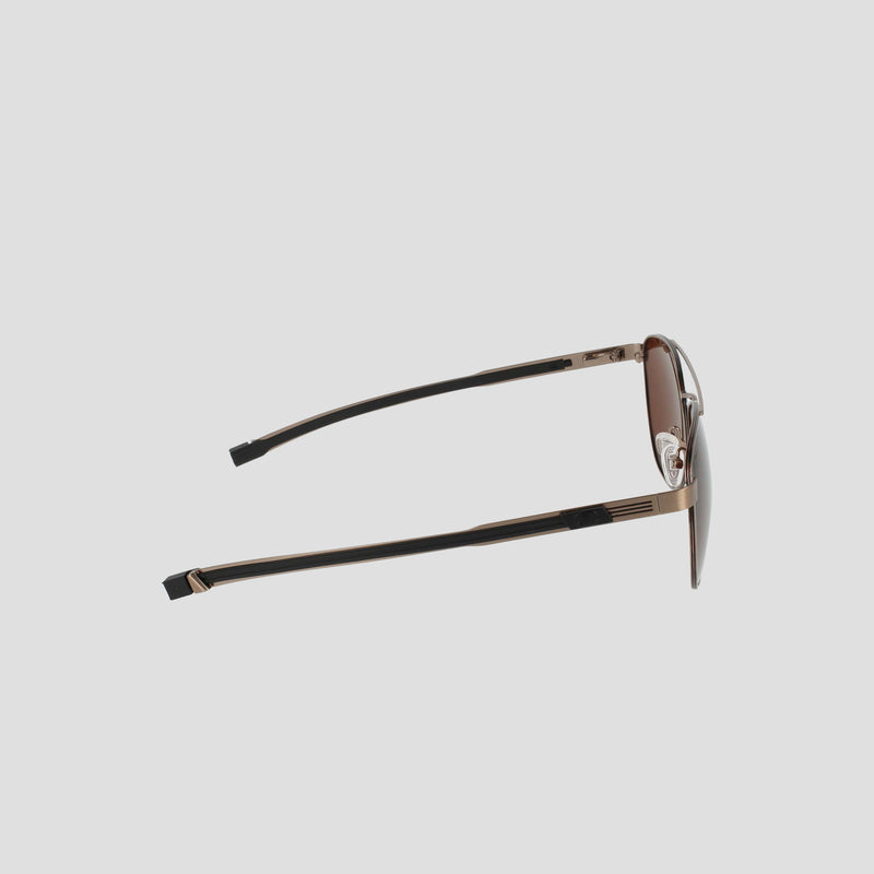 Side view of the Champion Men’s Polarized Retainer Stainless ST-Shirtl Aviator sunglasses, featuring brown-tinted polarized lenses, thin lightweight gold stainless steel frames, and black ear pieces, set against a plain light gray background.