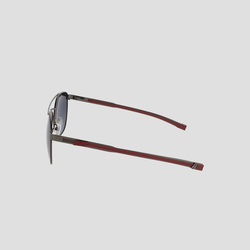 Side view of the Champion Men's Polarized Retainer Stainless ST-Shirtl Aviator sunglasses, featuring a lightweight stainless steel silver frame, dark polarized lenses, and burgundy arms, set against a plain light gray background.
