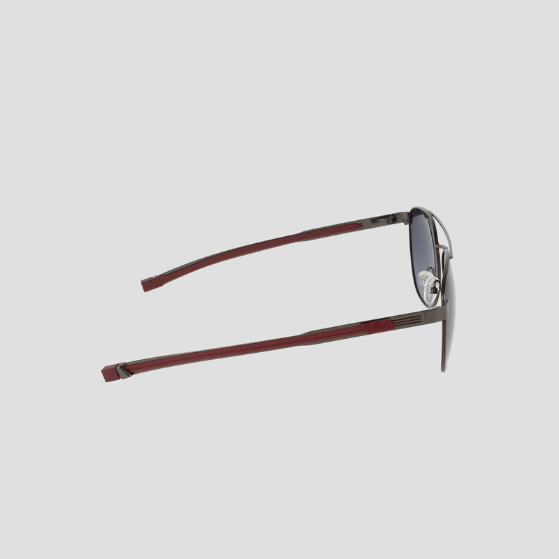 Side view of the Champion Men's Polarized Retainer Stainless ST-Shirtl Aviator sunglasses, featuring dark polarized lenses and slim, red stainless steel arms, displayed on a light gray background.