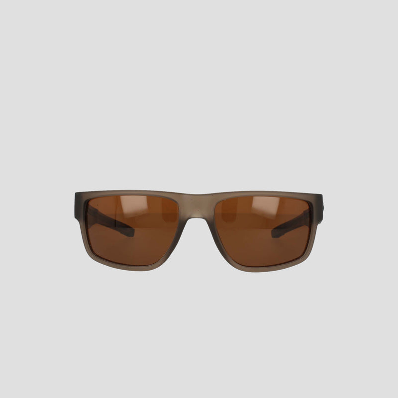 Front view of the Champion Men's Polarized Retainer Rectangle sunglasses, featuring rectangular translucent dark brown frames and brown tinted polarized lenses, set against a plain light gray background.